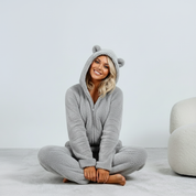 Gray fuzzy onesie with bear ears seated view