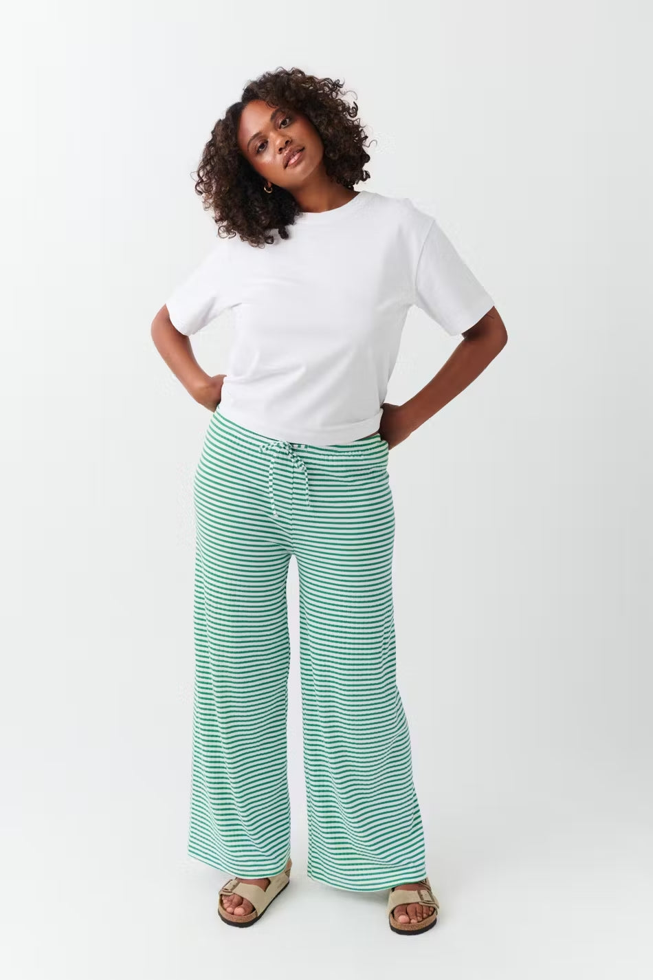 Wide-leg trousers green and white striped full-body front view