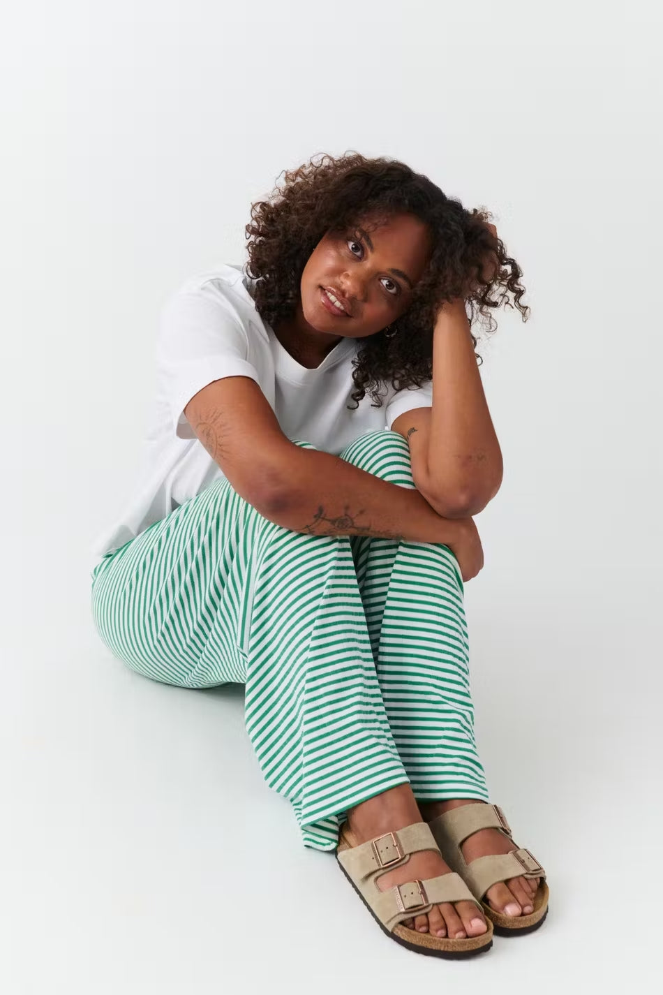 Wide-leg trousers green and white striped seated view