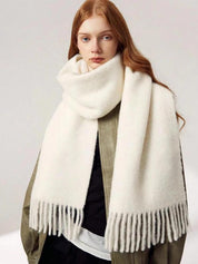 White scarf with fringe wrapped around neck front view
