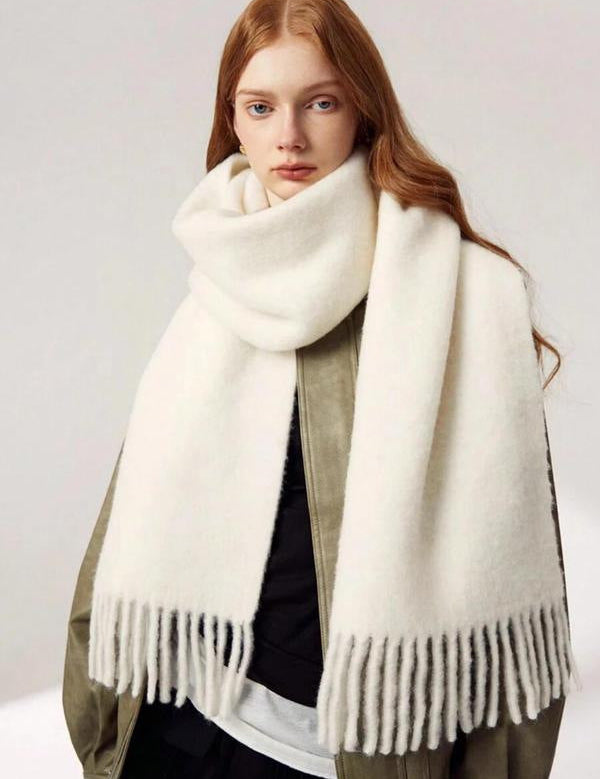 White scarf with fringe wrapped around neck front view