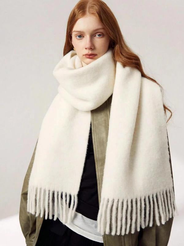 White scarf with fringe wrapped around neck front view