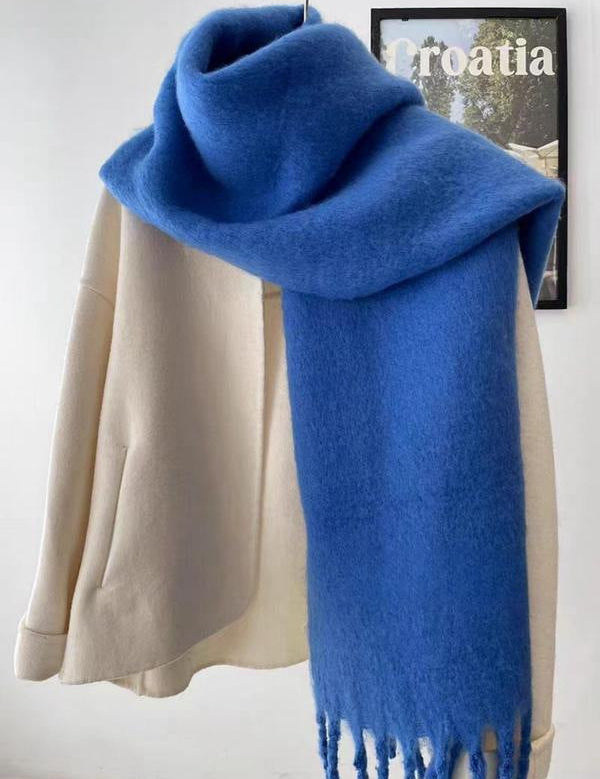 Blue scarf with fringe wrapped around neck front view