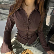 Brown striped shirt with bell sleeves close-up