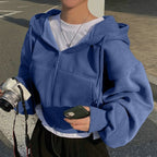 Blue zip-up hoodie with hood worn side view