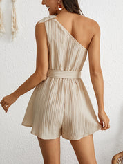 Beige jumpsuit with one-shoulder design and pleated fabric back view