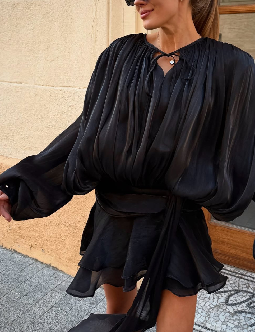 Black satin blouse with keyhole neck and peplum hem front view