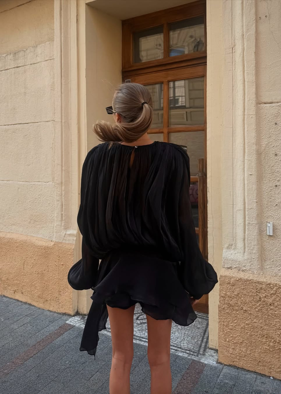 Black satin blouse with keyhole neck and peplum hem rear view