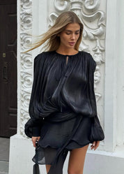 Black satin blouse with keyhole neck and peplum hem side view