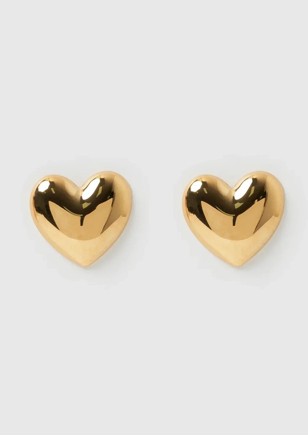 Gold heart-shaped stud earrings front view
