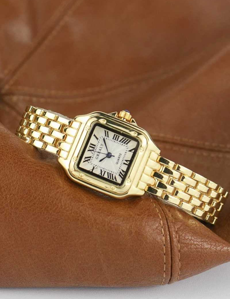 Gold wristwatch with Roman numerals and guilloche dial on brown leather background