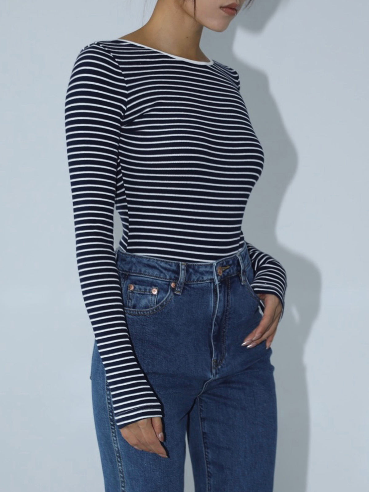 Striped long-sleeve top with deep low back, side view