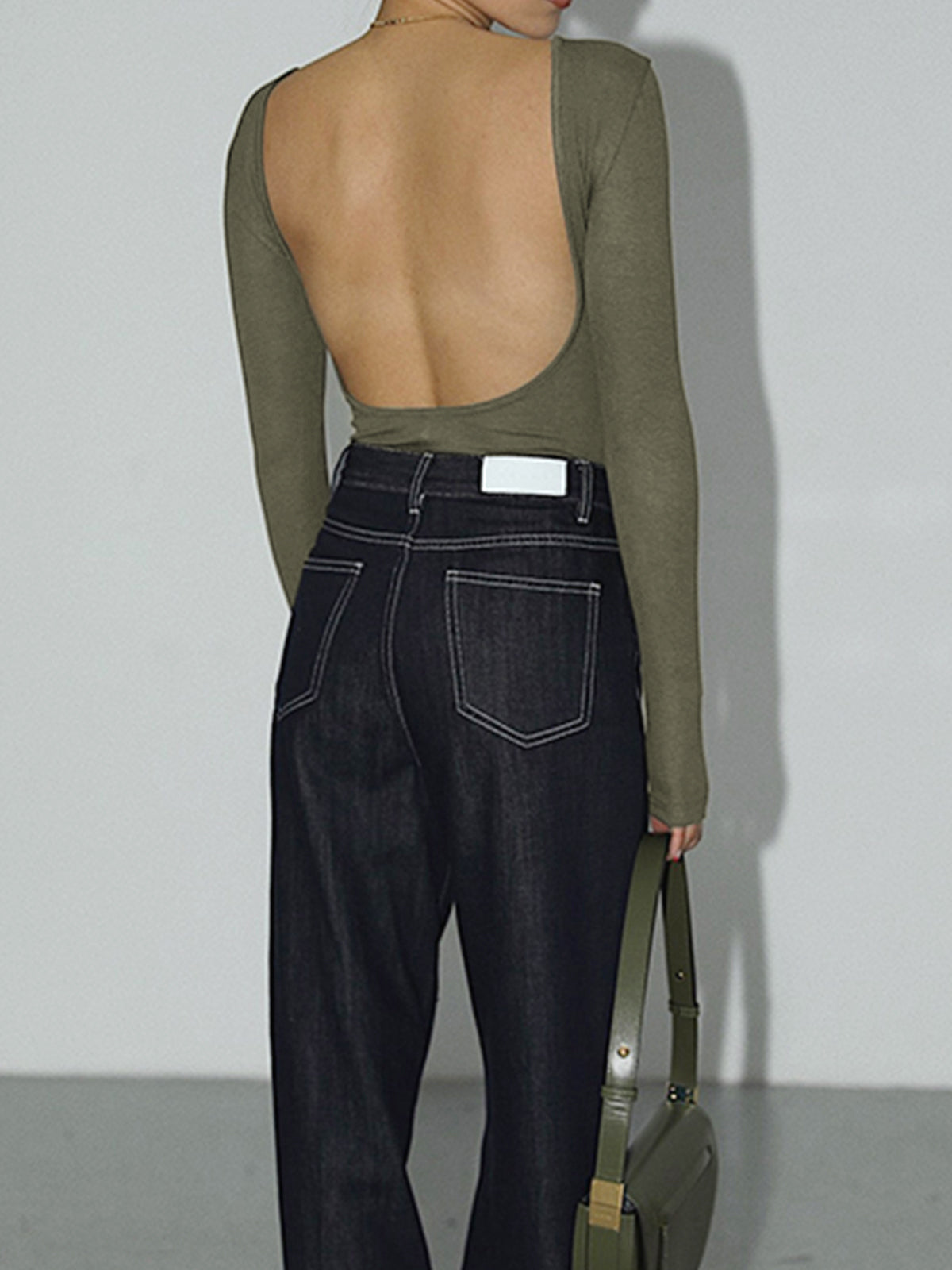 Army green bodysuit with open back, rear view