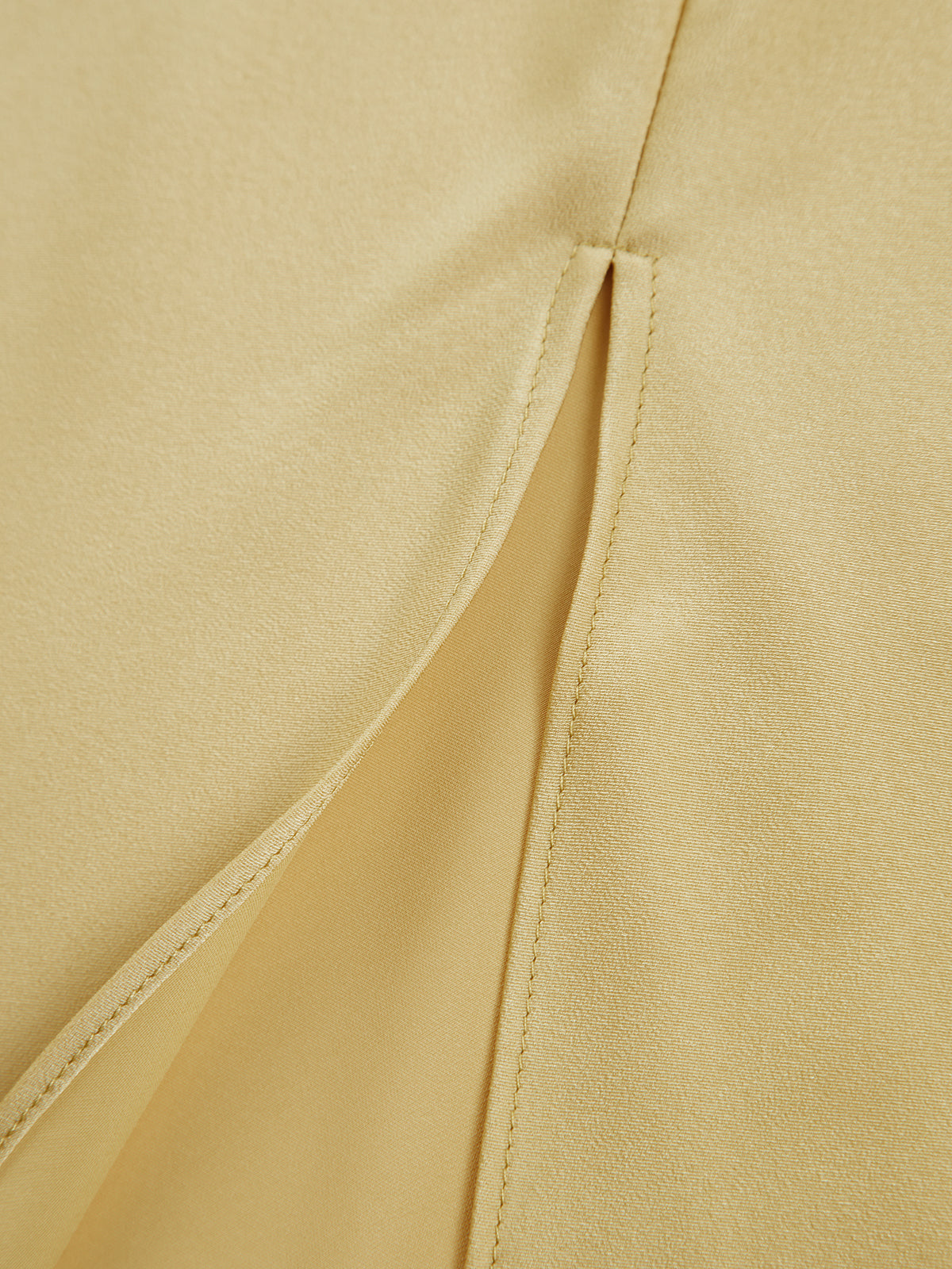 Evening dress yellow split detail close-up