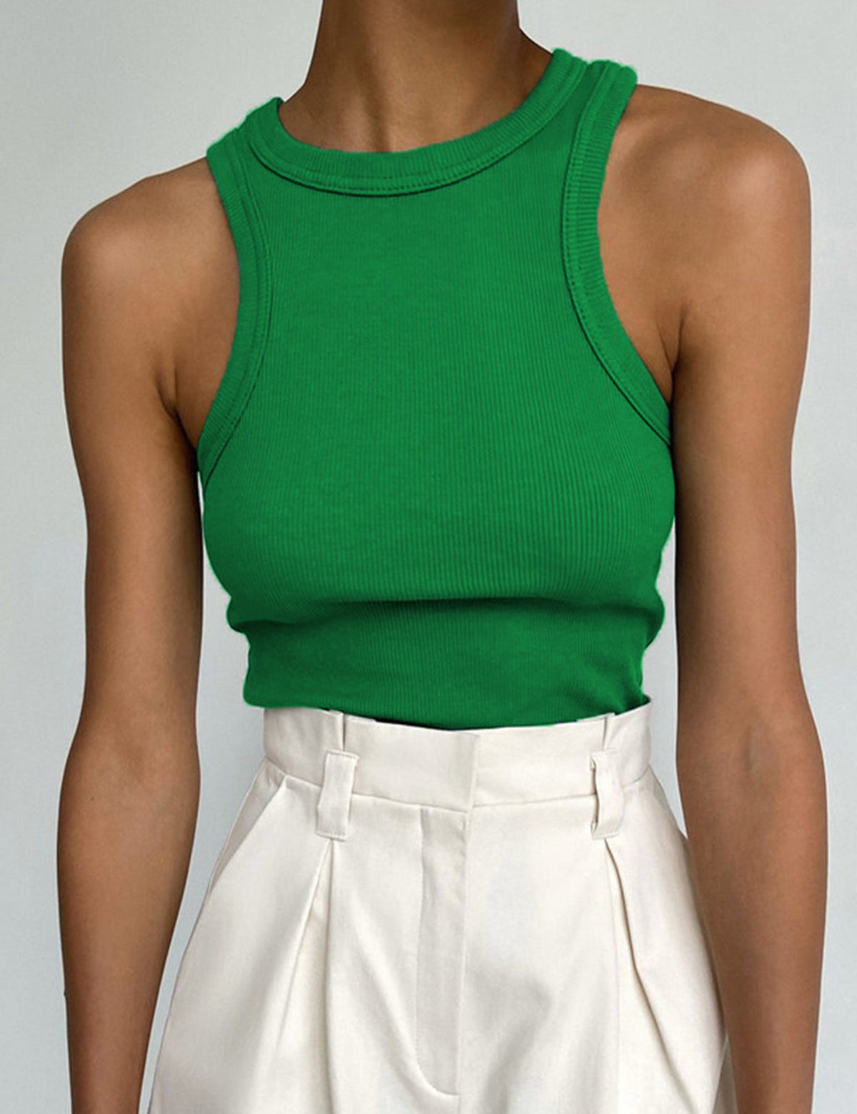 Green ribbed tank top front view with white pants