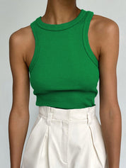 Green ribbed tank top front view with white pants