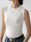 White sleeveless mock-neck top worn with jeans and belt side view
