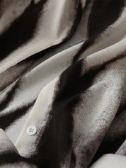 Casual blouse with abstract black and white print, close-up detail