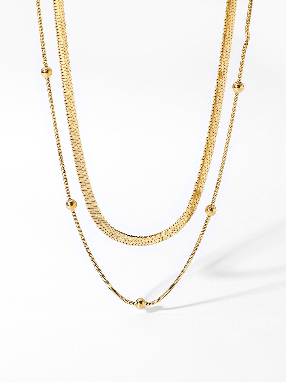 Gold necklace, double strand design, snake chain texture, pendant beads, isolated view