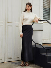 Cream knit sweater with open back and tie detail, side profile