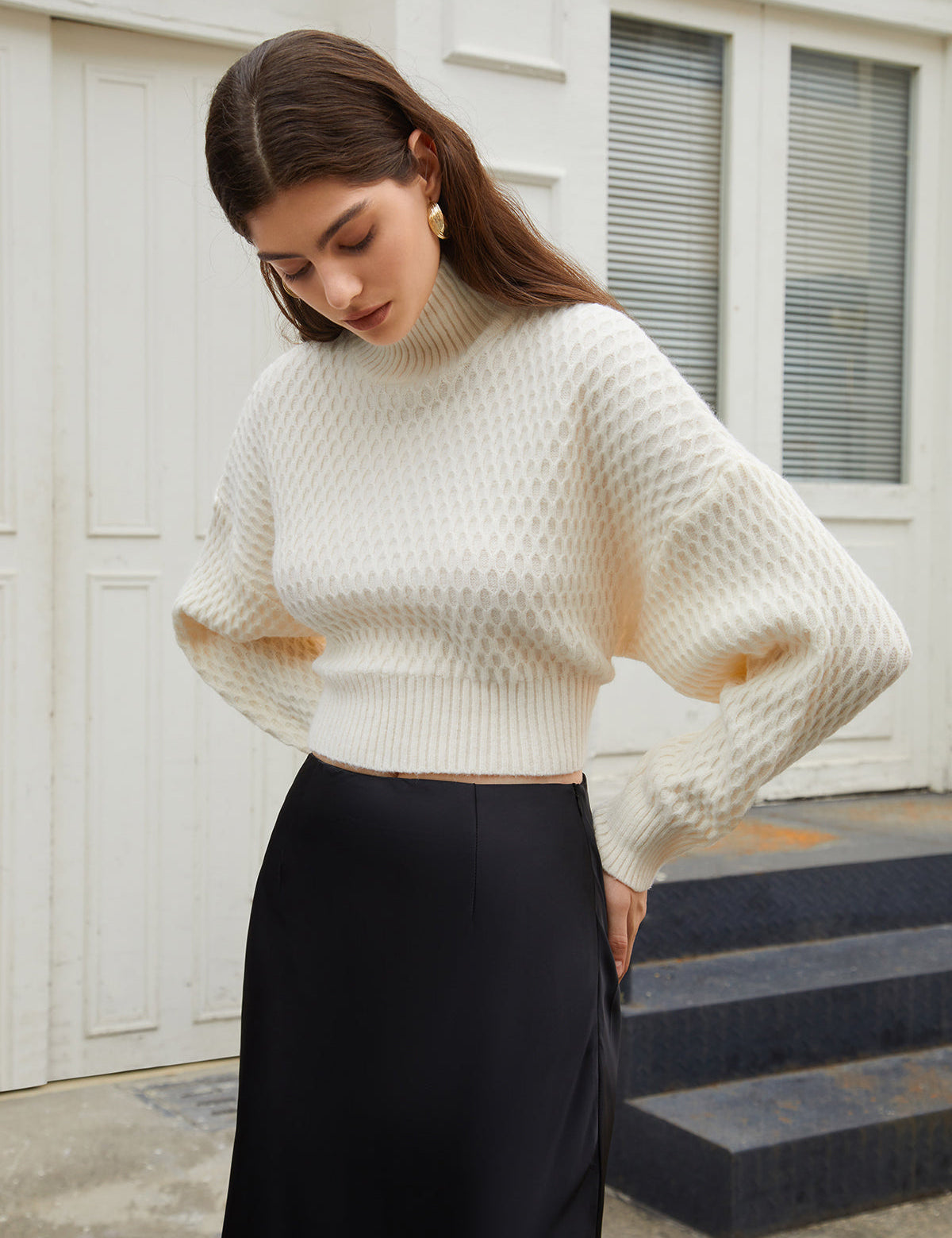 Cream knit sweater with open back and tie detail, front view