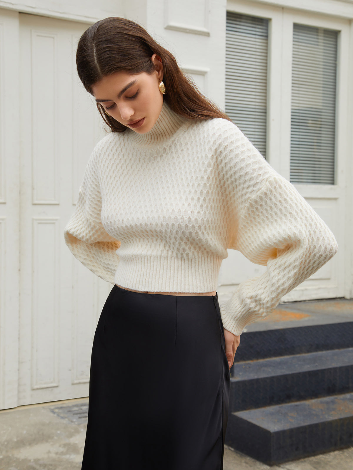 Cream knit sweater with open back and tie detail, front view