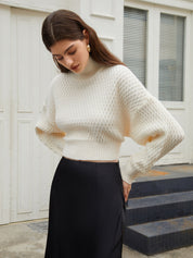 Cream knit sweater with open back and tie detail, front view
