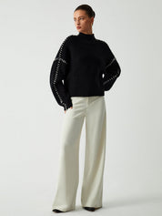 Black ribbed sweater with white dotted trim full body view