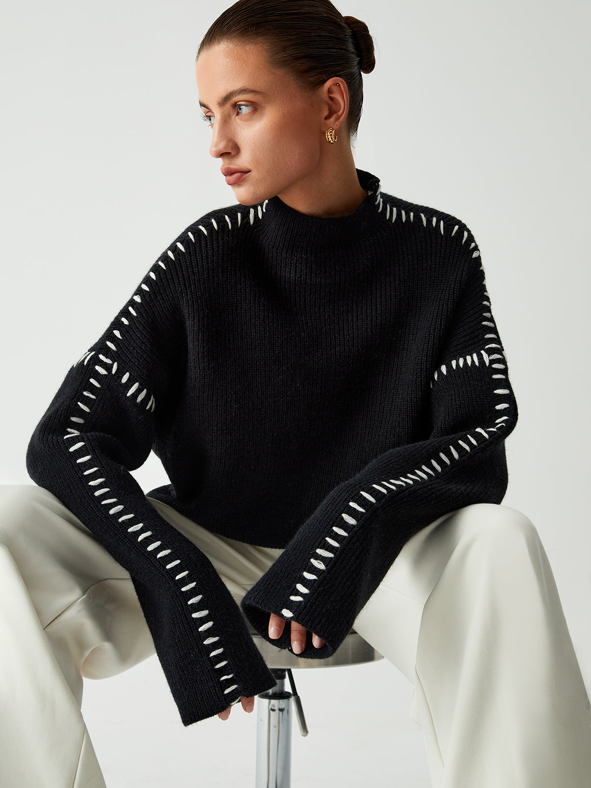 Black ribbed sweater with white dotted trim seated view