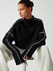Black ribbed sweater with white dotted trim seated view