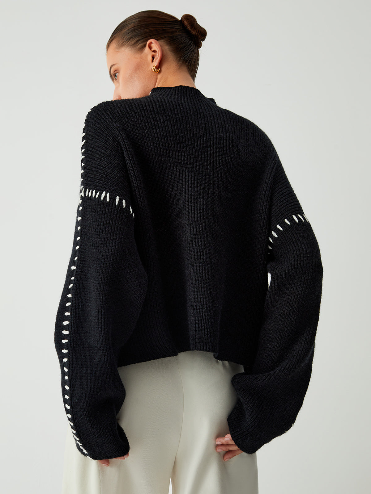 Black ribbed sweater with white dotted trim back view