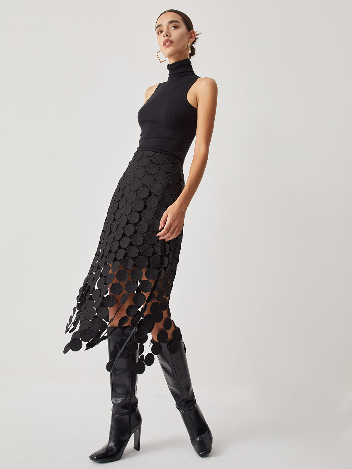 Evening skirt with circular cutouts and fringe detail, side profile