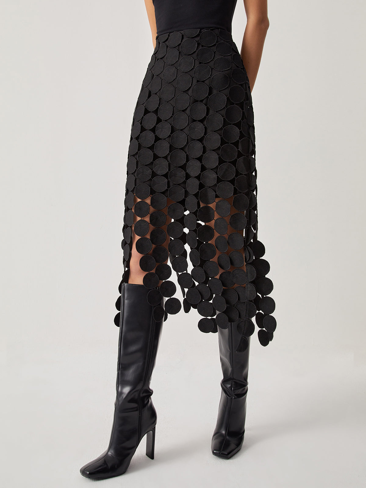 Evening skirt with circular cutouts and fringe detail, front view