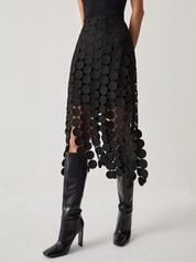 Evening skirt with circular cutouts and fringe detail, front view