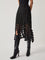 Evening skirt with circular cutouts and fringe detail, front view