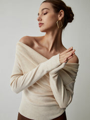 Cream off-shoulder sweater with draped neckline, close-up detail