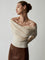 Off-shoulder cream sweater with draped neckline, side view