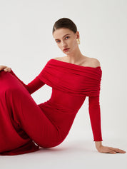Red off-shoulder dress with ruched bodice seated pose