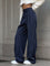Navy pinstripe trousers with white sweater and sneakers