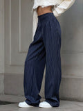 Navy pinstripe trousers with white sweater and sneakers