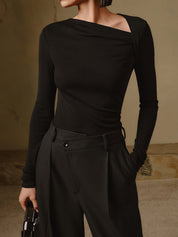 Black asymmetrical neck top with ruched detail front view