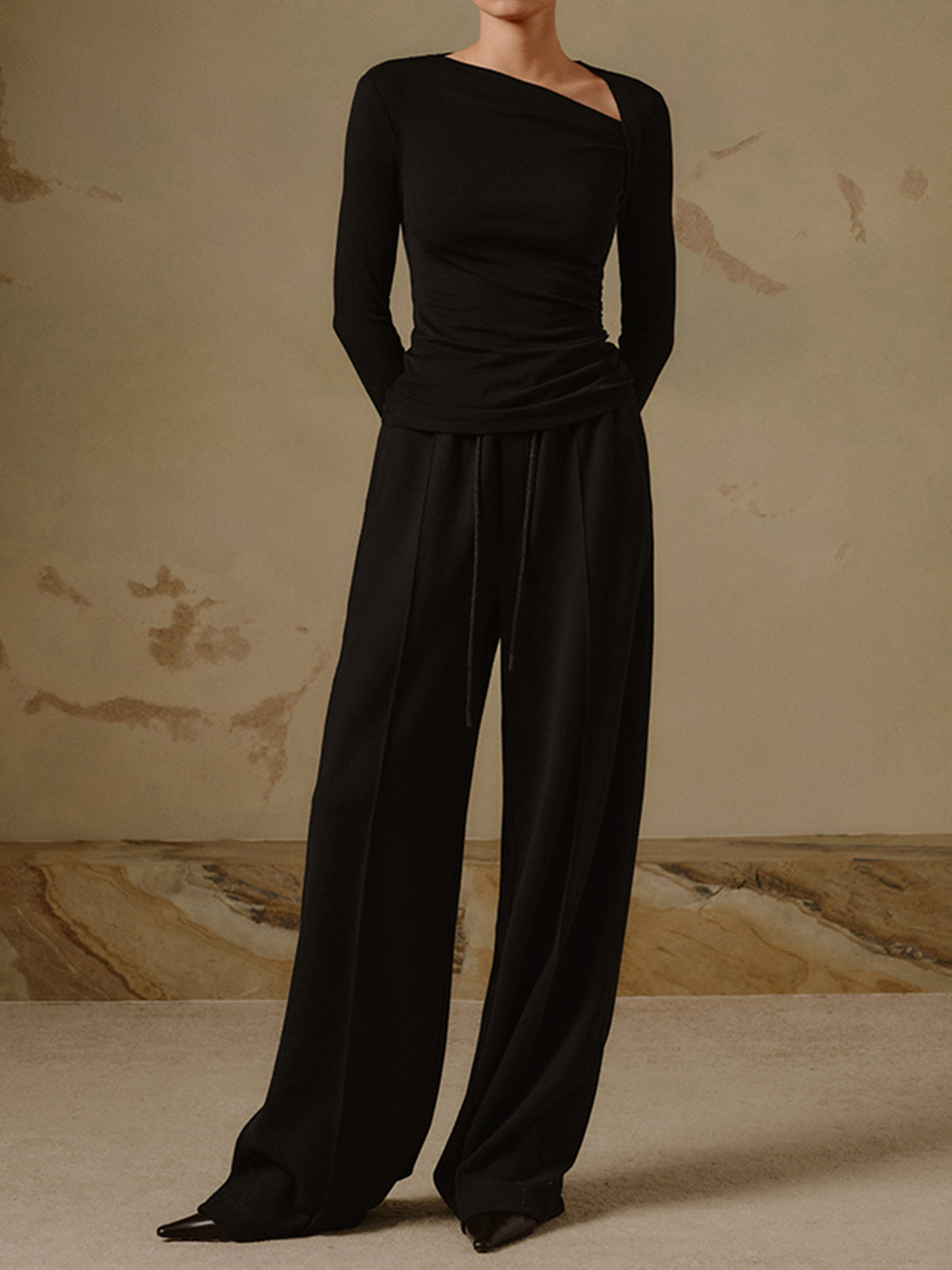 Black asymmetrical neck top with ruched detail full body view