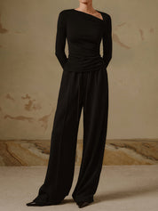 Black asymmetrical neck top with ruched detail full body view