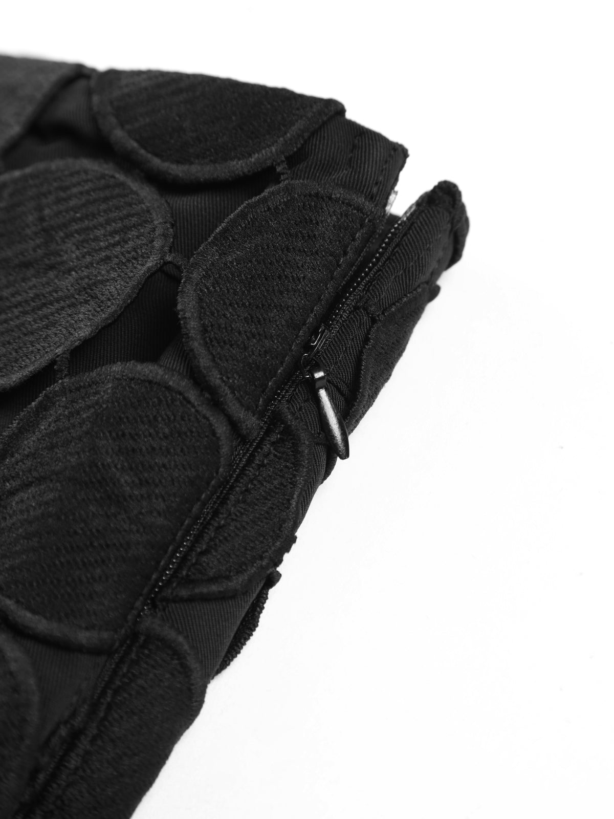 Evening skirt with circular cutouts and fringe detail, zipper close-up
