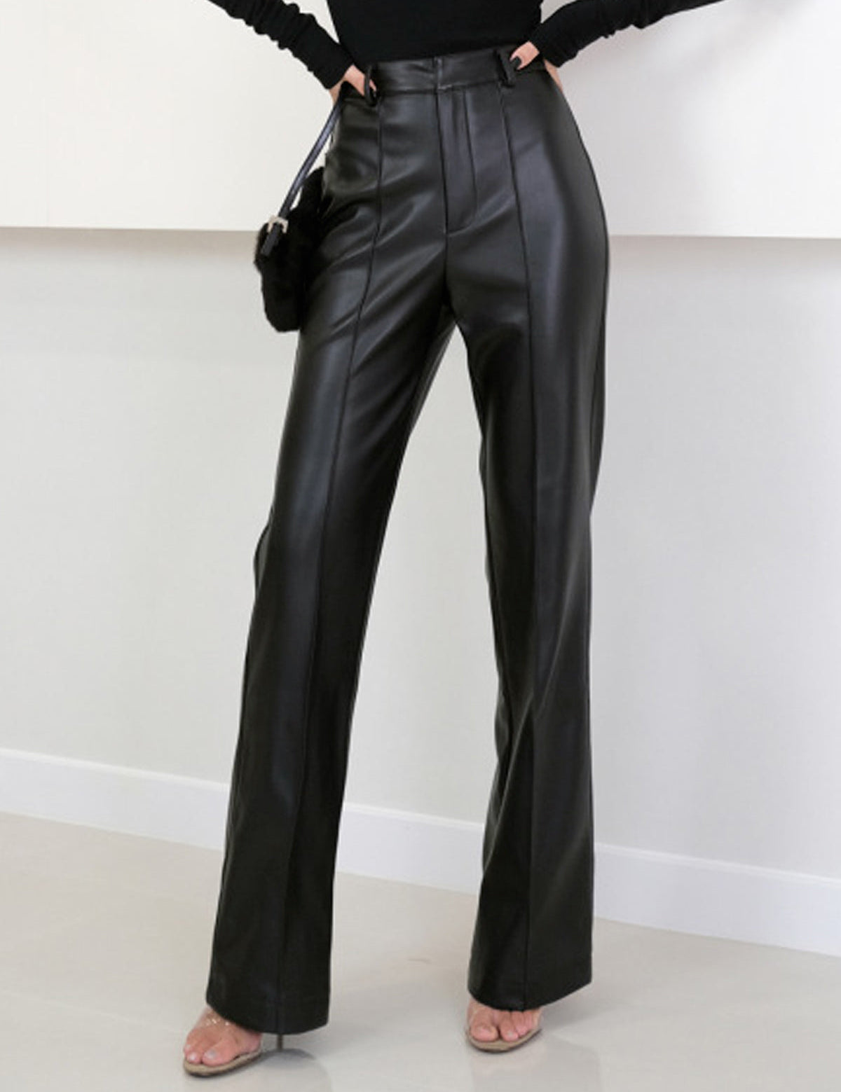 Black faux leather pants side view with handbag
