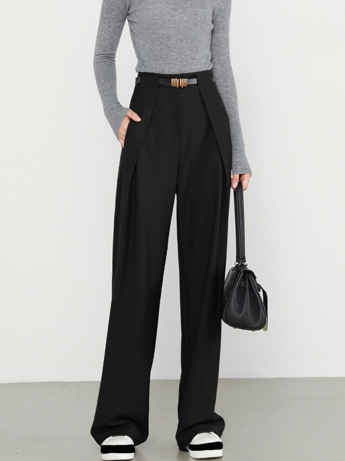 Black wide-leg trousers with gold belt buckle front view