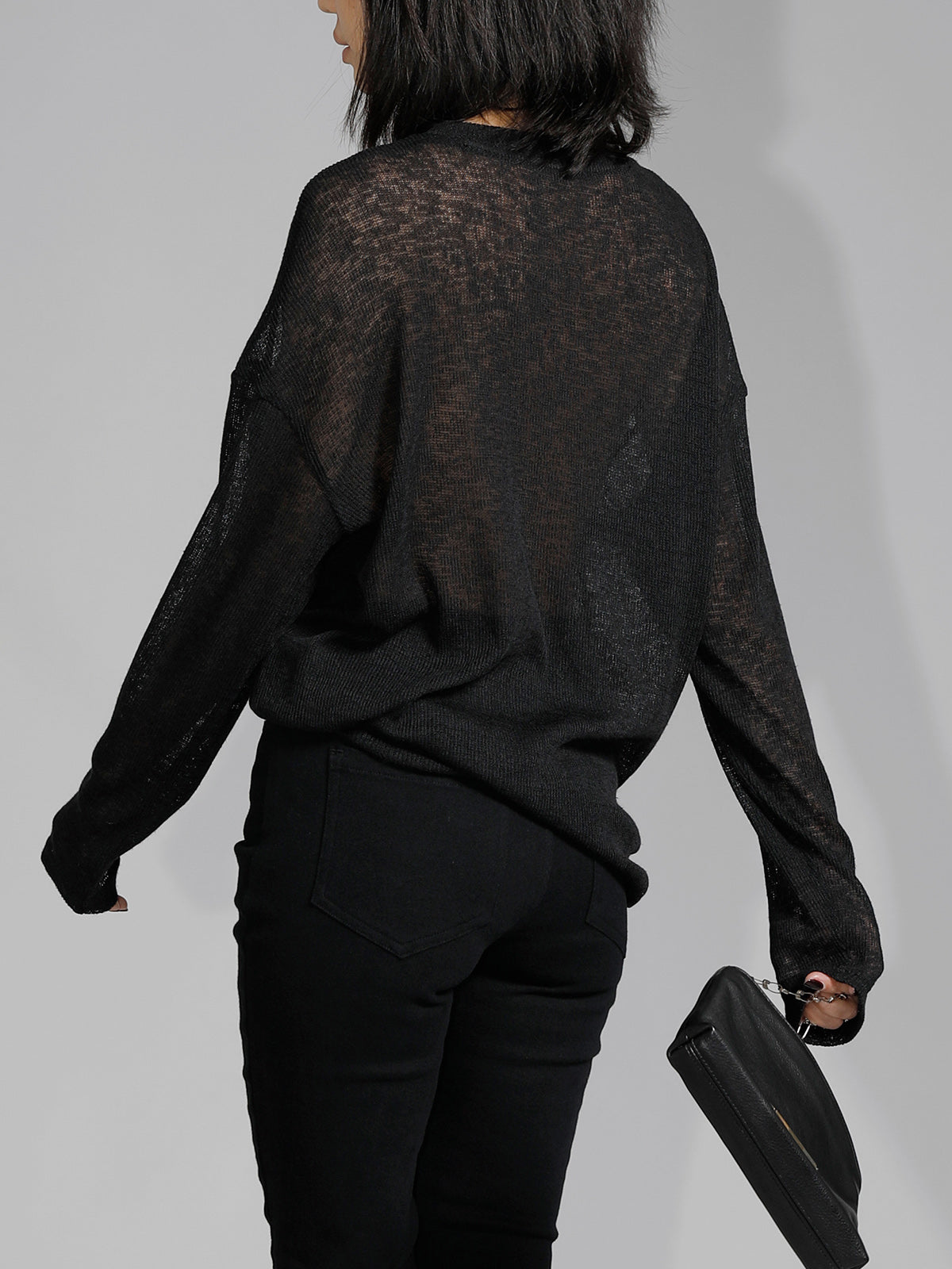 Off-shoulder sheer black sweater back view