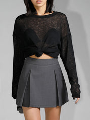Off-shoulder sheer black sweater with pleated skirt detail