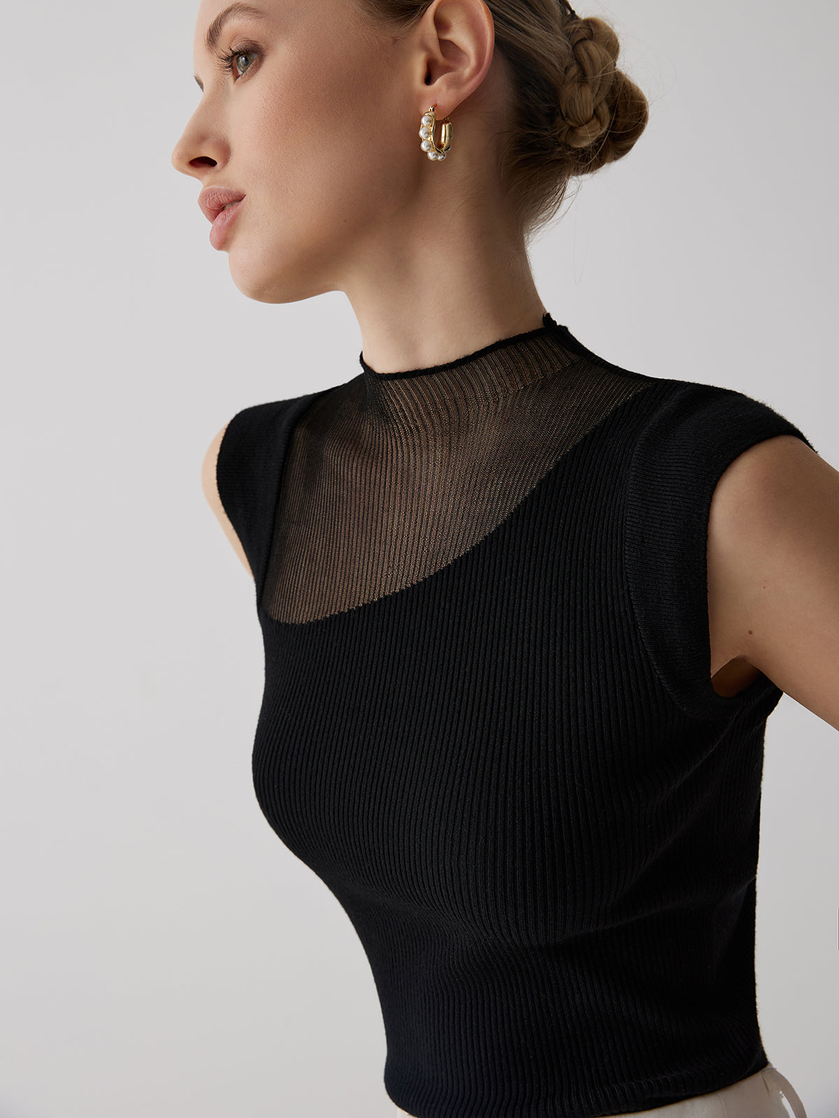 Black ribbed sleeveless top with sheer panel close-up side detail