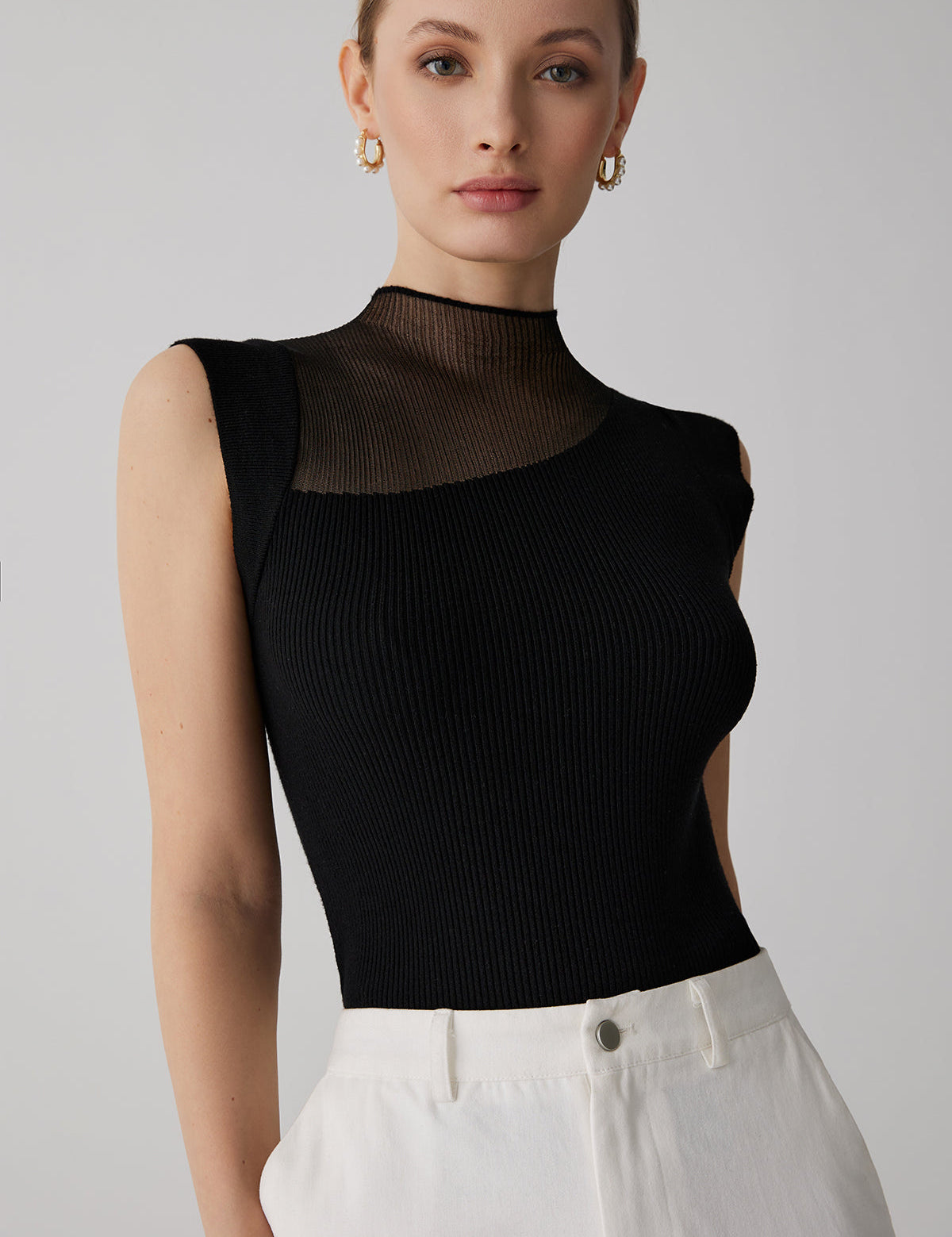 Black ribbed sleeveless top with sheer panel front view